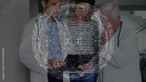 Holo orb appearing then fading over tablet patient junior Dr tapping senior Dr thinking case review