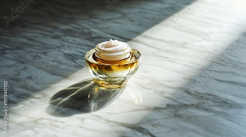 Open jar of skin cream on marble table with sunlight and no people
