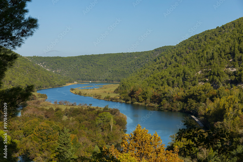 Fototapeta premium River winding through green hills aerial landscape