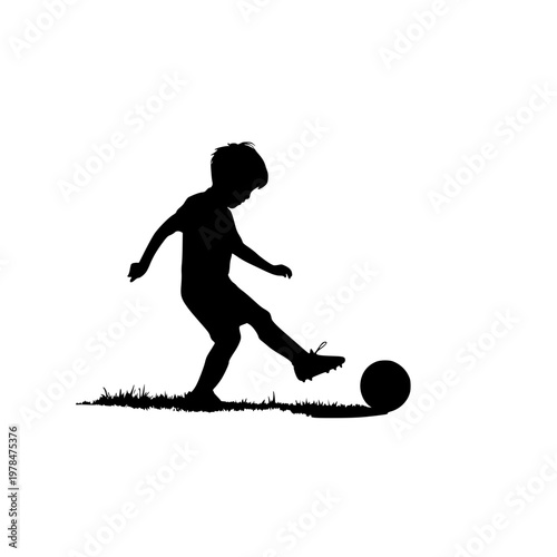 Silhouette of young boy kicking soccer ball on grassy field with white background