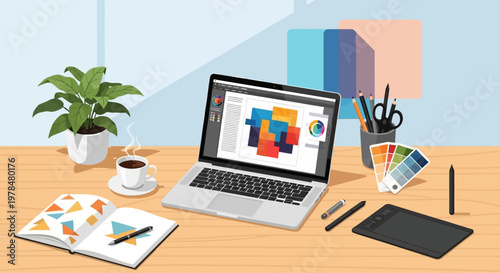 Creative workspace with laptop showing graphic design software and color swatches on desk.