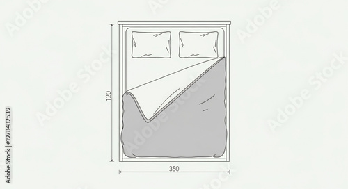 Top view of a neatly made bed with pillows and blanket.