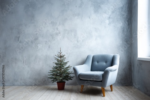 Minimalist room with blue armchair and small pine tree.