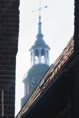 Ancient clock tower watches over the quiet, sun-drenched rooftops.