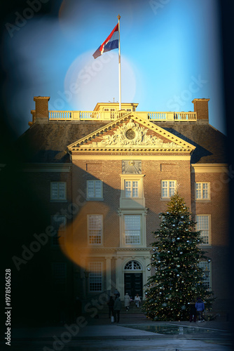 Golden hour light bathes historic facade, illuminating festive cheer.