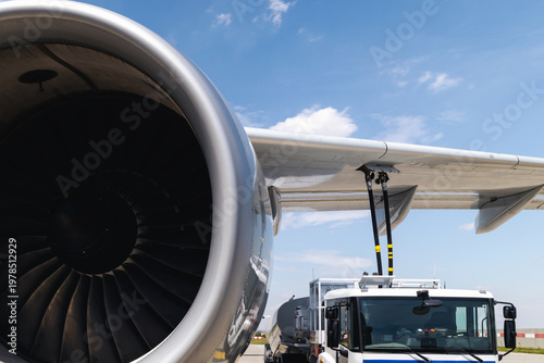 Refueling of airplane at airport. Ground service before flight.