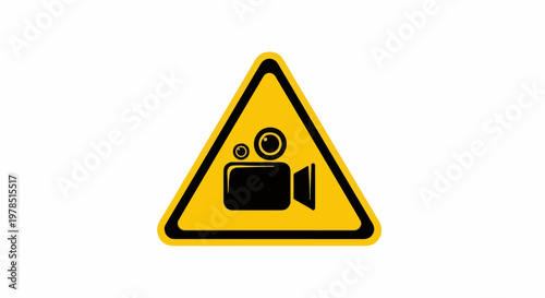 Warning triangle with black video camera symbol on yellow background