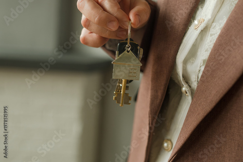 New owner of apartment holding bunch of keys in hand. Purchase or renting of real estate. Moving, relocation.