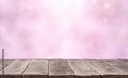 Soft pink background with wooden table and gentle bokeh light. Minimal product display mockup with copy space, ideal for cosmetics, beauty branding and advertising