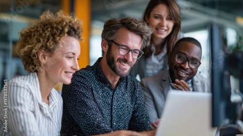 Diverse group of colleagues collaborating and focused on a digital project