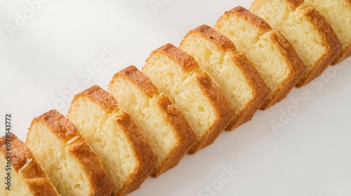 Sliced lemon pound cake with golden brown crust on white background perfect for bakery or dessert concepts