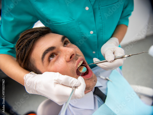 Man receiving dental checkup in clinic.