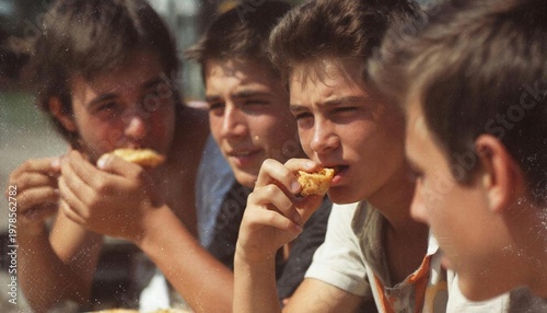 A group of teenagers eating street food outdoors