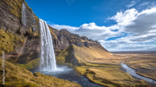 A stunning view of a waterfall cascading over rocky cliffs in a lush landscape. The vibrant blue sky and rolling hills create a serene atmosphere. Ideal for nature lovers and travel enthusiasts. AI