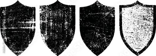set of four distressed shield emblems with vintage grunge texture in black and white