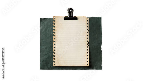 Black binder clip holding lined paper on dark textured slate, isolated on transparent background