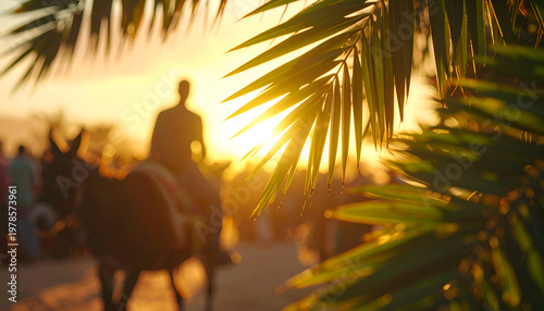 Silhouette of a person riding a donkey at sunset, framed by palm leaves.