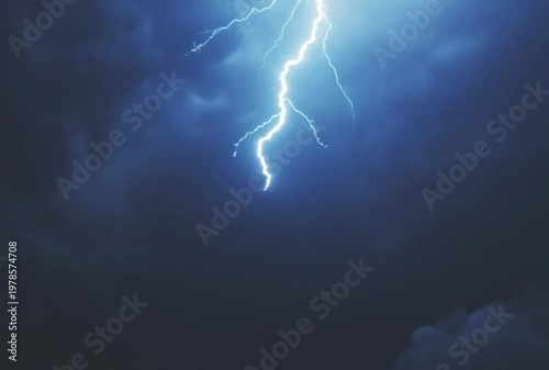 Electric blue lightning striking during a stormy night sky with dramatic cloud formations
