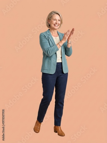 Smiling woman applauding in a blazer and trousers