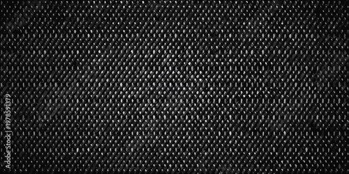 Close up of a dark textured fabric with a repeating diamond pattern