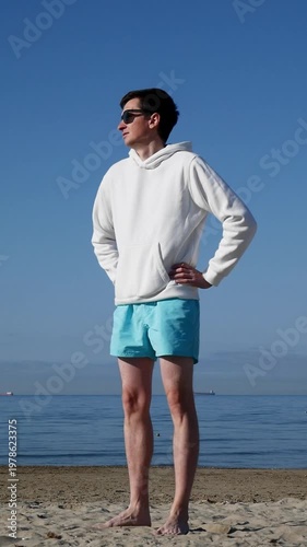 Man doing morning beach workout, energetic fitness training, healthy lifestyle, outdoor physical activity.