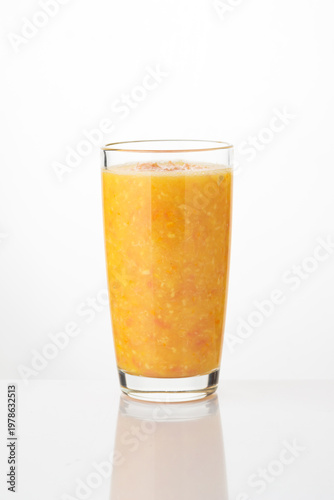 Quadro su tela A tall glass filled with a thick, vibrant orange smoothie, showcasing its pulpy