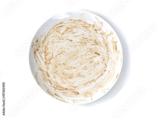 Dirty empty white plate after meal isolated on white background. perfect for themes of food waste, hunger, finished dinner, or dishwashing concepts