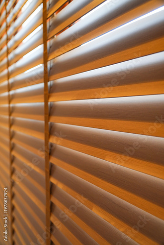 window blinds are brown and the view outside is blurry. The light is dim and the room is cozy