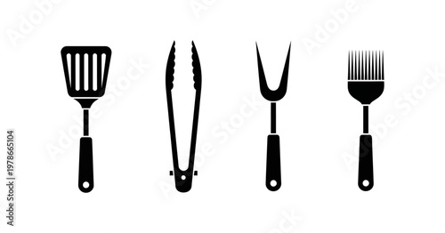 Set of black barbecue utensils including a spatula, tongs, fork, and basting brush, isolated on a white background