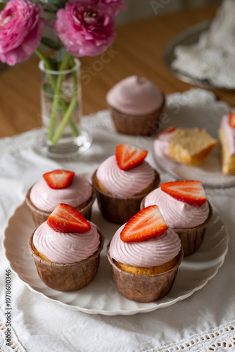 Vanilla Cupcakes with Fresh Strawberry and Pink Frosting on a Plate