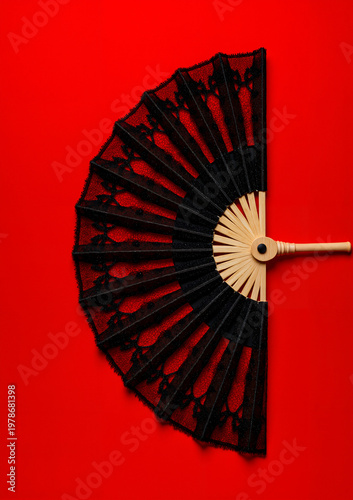 Black decorative fan on red background for Halloween decoration  