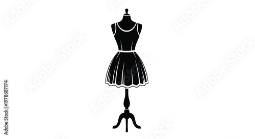 Solid black silhouette of a sleeveless dress is displayed on a dressmaker mannequin stand for fashion design and boutique retail concepts.