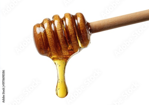 Dripping golden honey from a wooden dipper against a white background