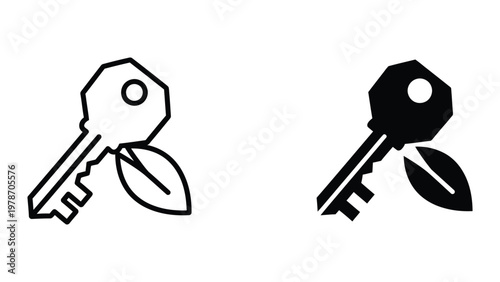A black and white image of two keys with leaves