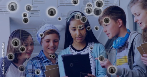 Photos Gathering five students leaning over tablet at school, showing headband, noteboo
