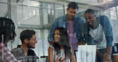 Analyzing market charts, five coworkers in office wear clustered around monitor with coffee cup