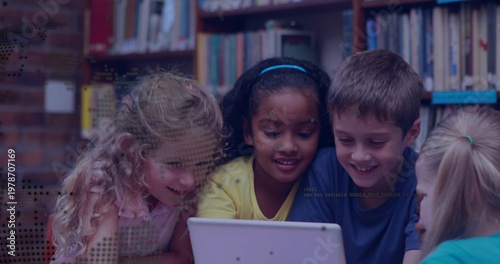 Leaning four students watching white tablet near bookshelves, wearing colorful clothes and stickers