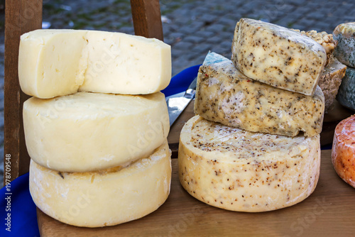 Traditional organic cheese selection sold outside on local market stall