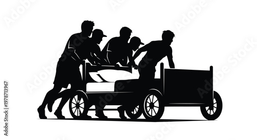 Four people pushing a cart with a fifth person lying down on it