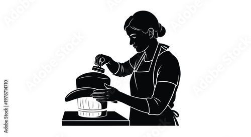 A woman in an apron using a manual food processor on a table