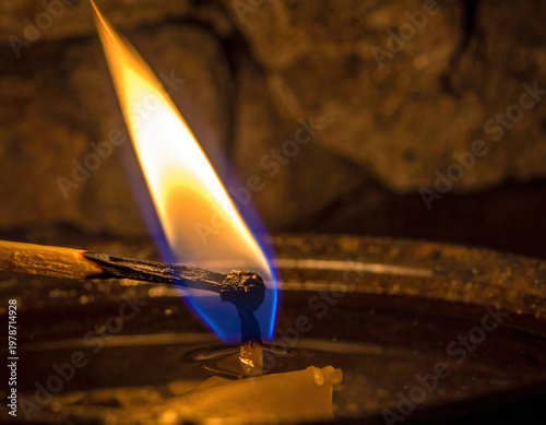Flickering candle flame intimate setting close-up photography dark atmosphere moody contrast near burnout concept