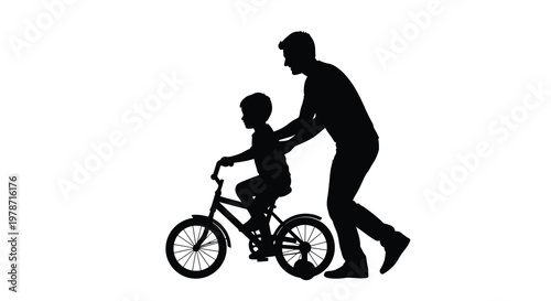 A silhouette of a father helping his son learn to ride a bicycle