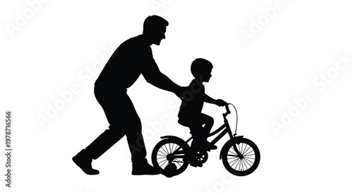 Father teaching son to ride a bicycle in a silhouette
