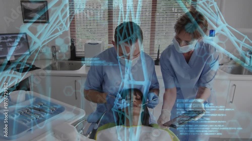 Vertical video: Patient lying as dentist working mouth and asst using tablet, DNA holo aiding care