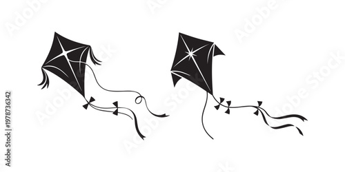 Two traditional diamond-shaped kites flying with long tails in the sky