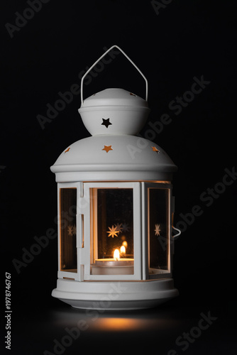 Christmas candlelight with glowing candle on black background