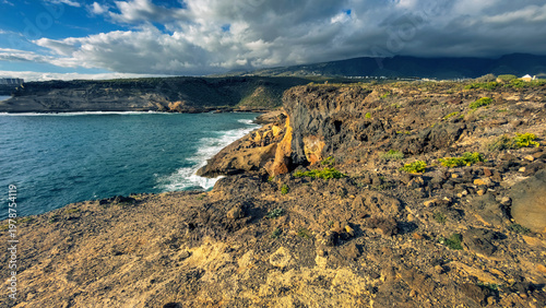 Colorful volcanic cliffs and turquoise ocean in La Caleta Tenerife Canary Islands
