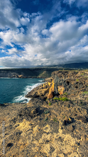 Colorful volcanic cliffs and turquoise ocean in La Caleta Tenerife Canary Islands
