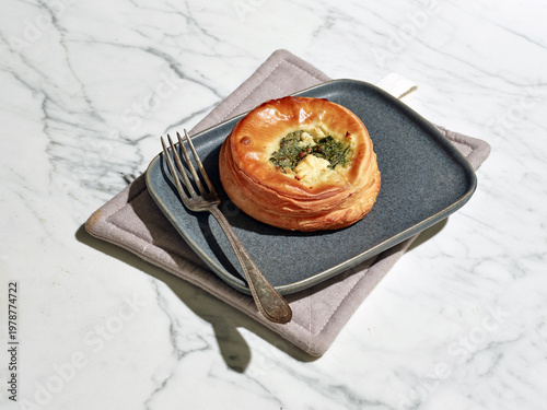 Savory spinach and goat cheese pastry on plate with hard light