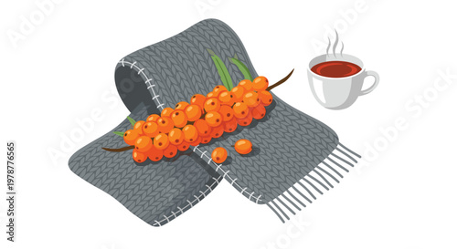 A folded grey wool scarf supports a vibrant branch of orange sea buckthorn berries next to a hot cup of dark tea against a clean white background.